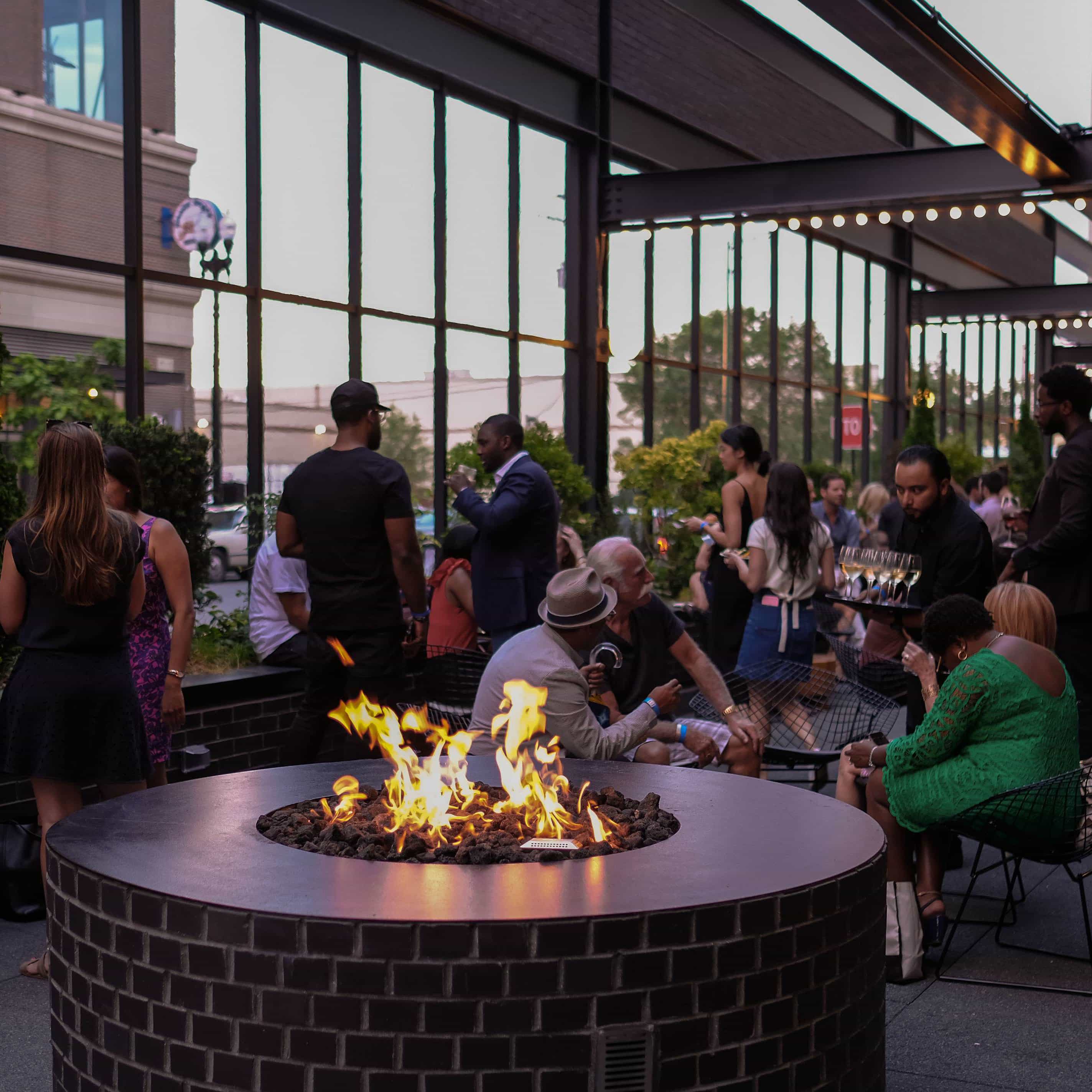 Outdoor firepit with people gathered in a Chicago neighborhood